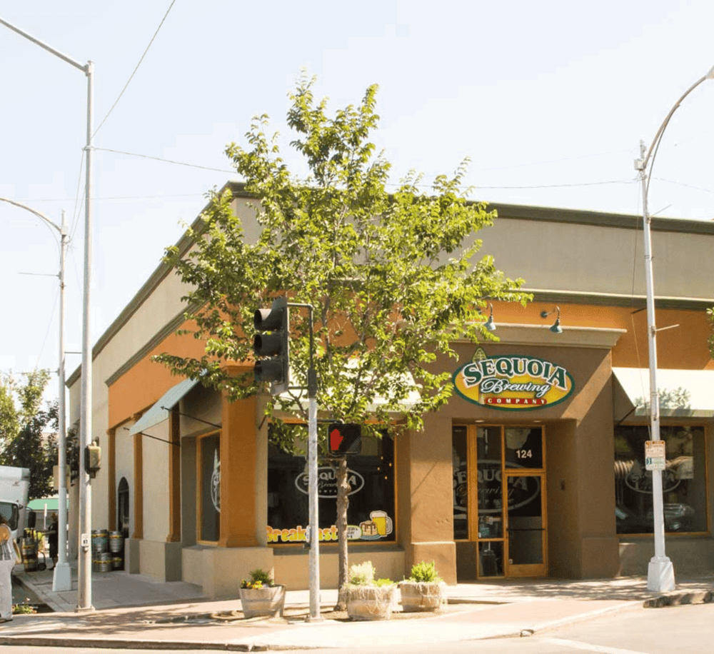 Sunny exterior of Sequoia Brewing Company restaurant and bar on a city street.
