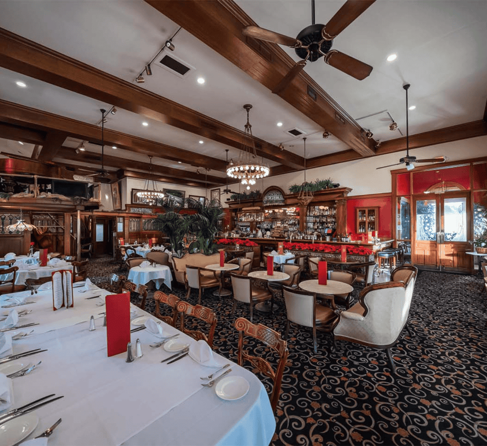 Elegant restaurant interior with classic wooden accents and festive holiday decorations.