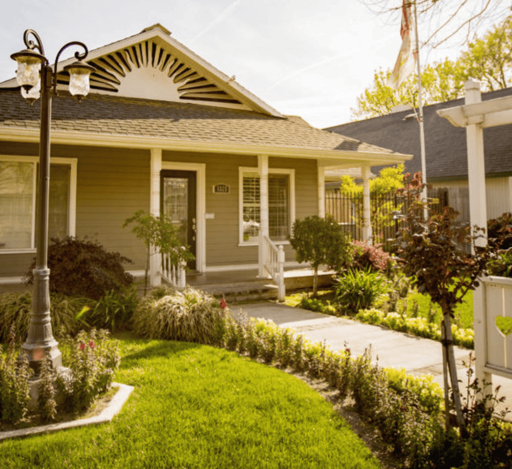 Charming American suburban home with lush garden and colorful flowers.