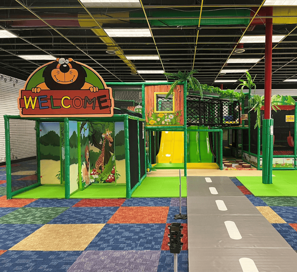 Colorful indoor jungle gym for kids with slides, tunnels, and play structures at QuestForDirections.
