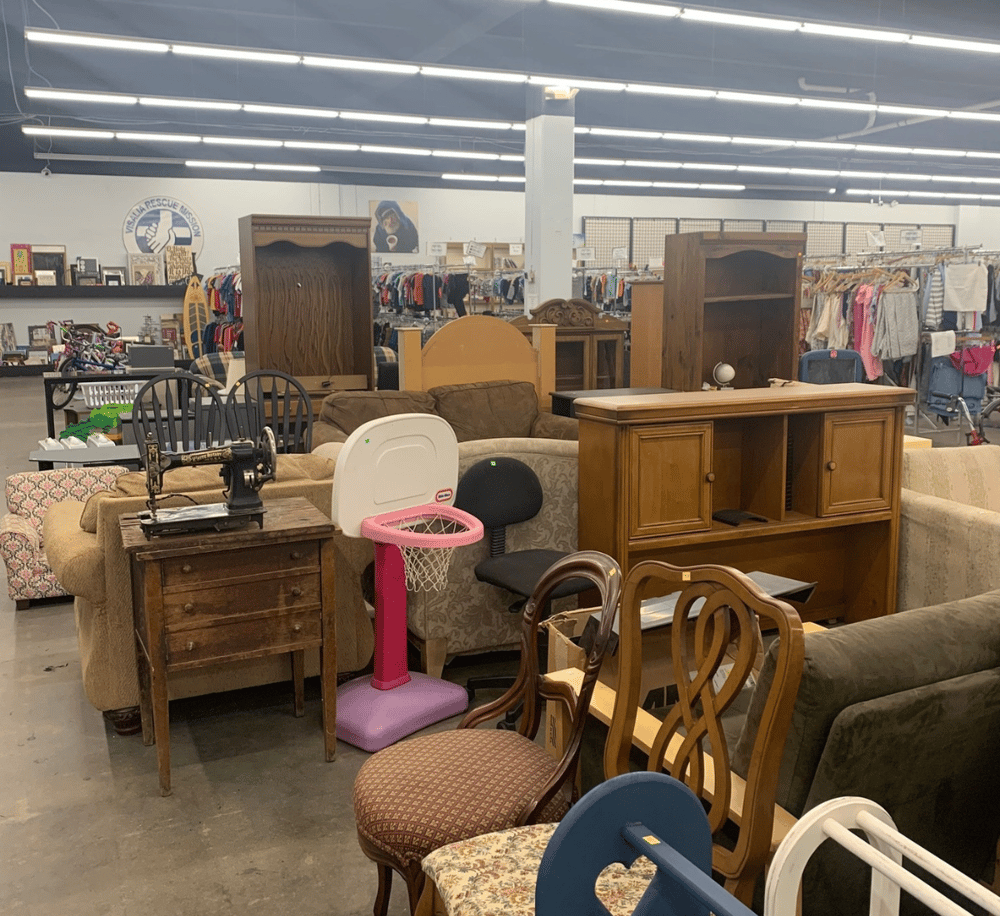 Vintage furniture and household items at thrift store auction sale.