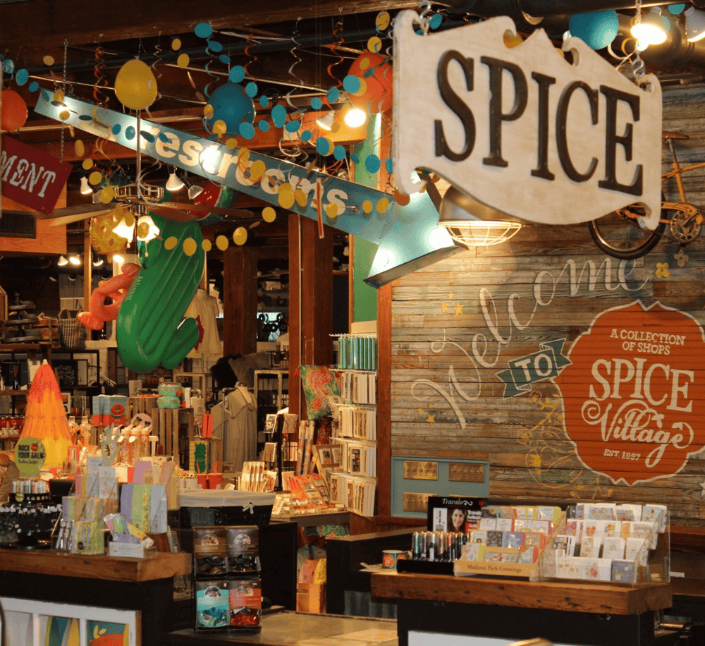 Colorful shop interior with festive decorations and signs at Spice Village market.