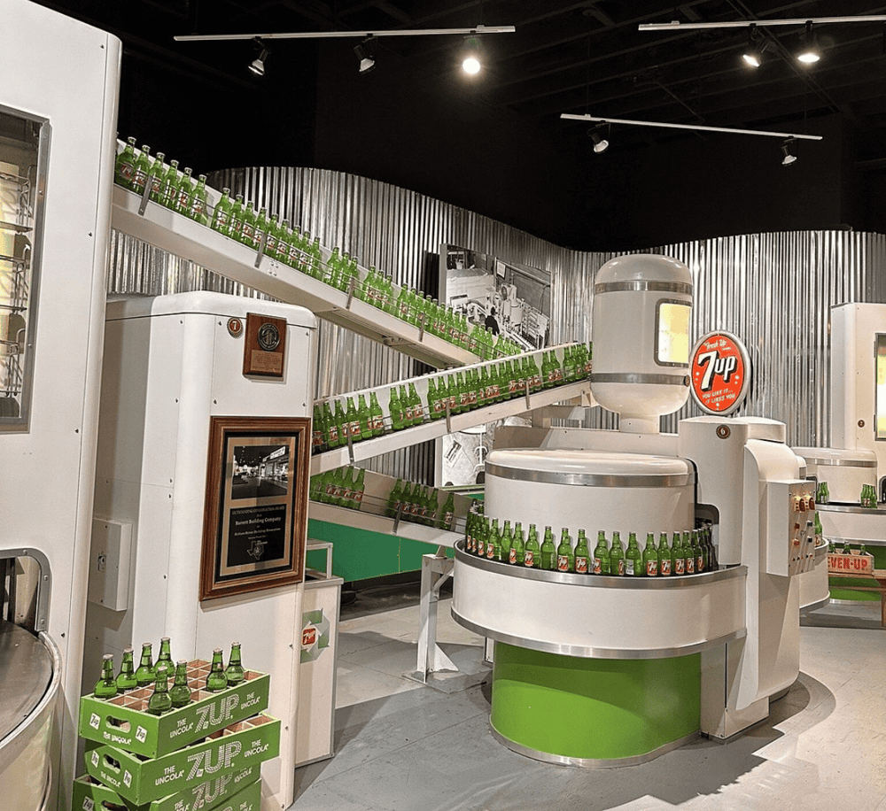 Bottle vending machine for 7up soft drink, vintage soda machine display, nostalgic beverage dispenser, 7up product showcase, retro soda vending display.