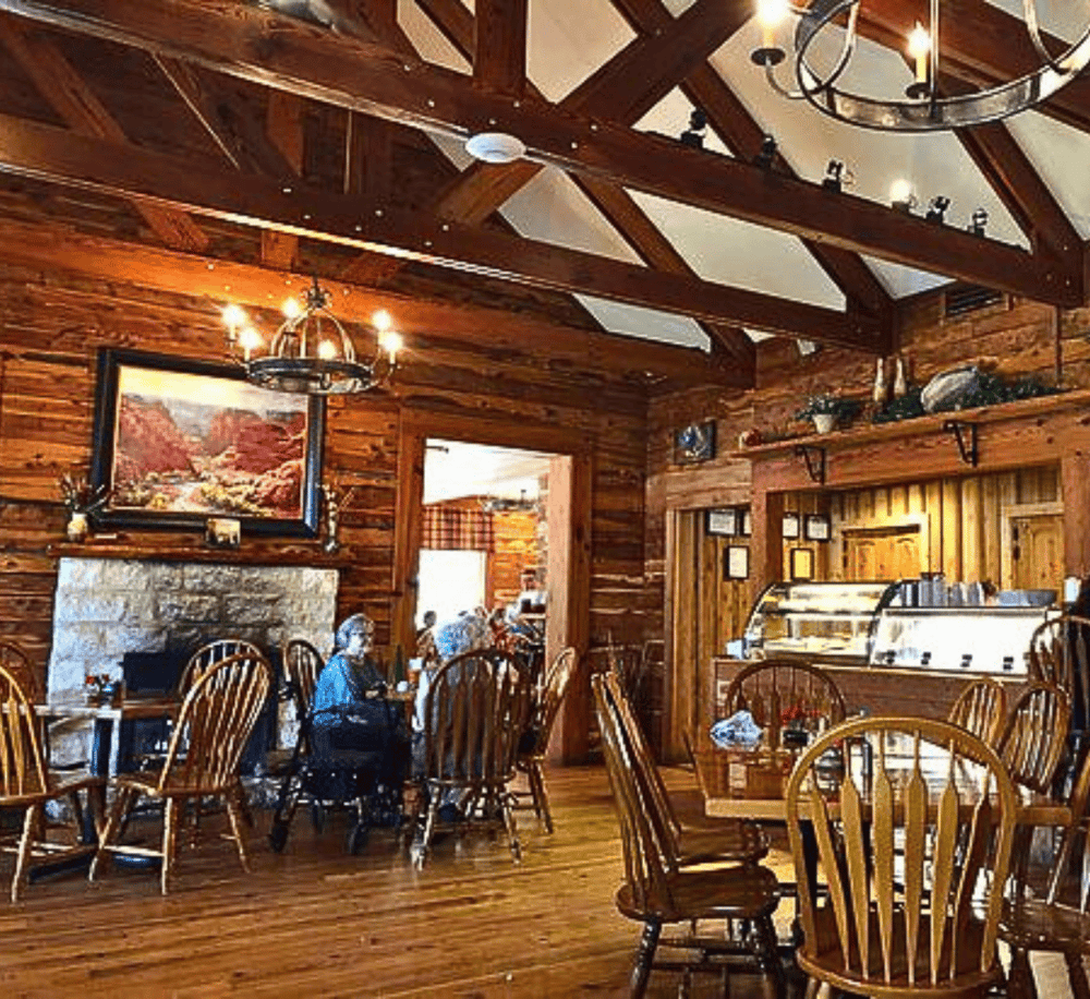 Cozy rustic restaurant interior with wooden beams and warm lighting, perfect for a homey dining experience.