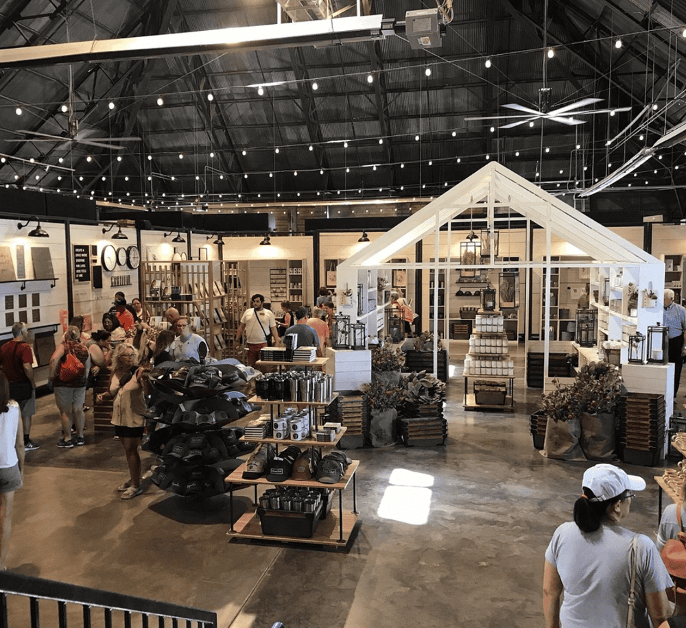 Modern home decor store interior with shoppers exploring furniture and accessories, showcasing QuestForDirections solutions.