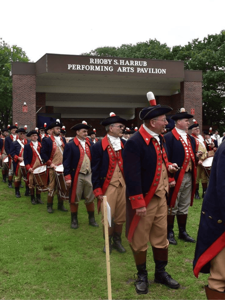 Colonial reenactors in historical costumes at Rhoby S. Harrub Performing Arts Pavilion.
