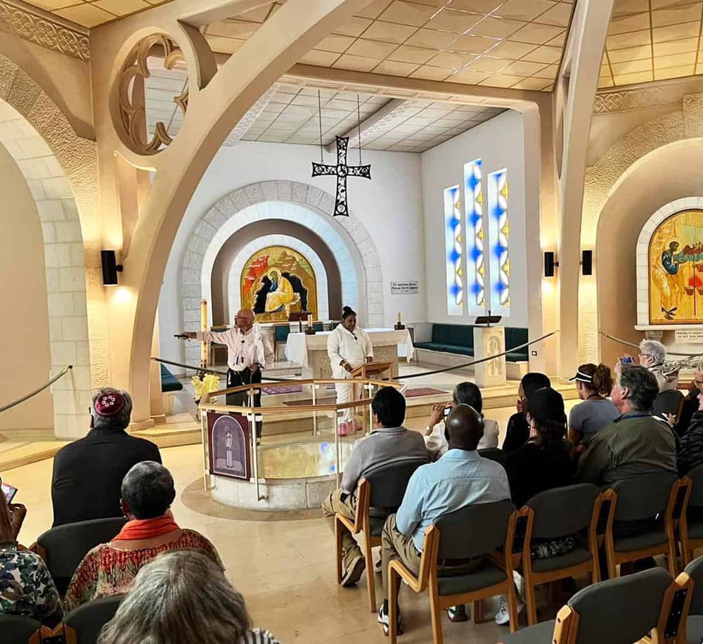 1. Modern church interior with altar, stained glass windows, and congregation seated for service.