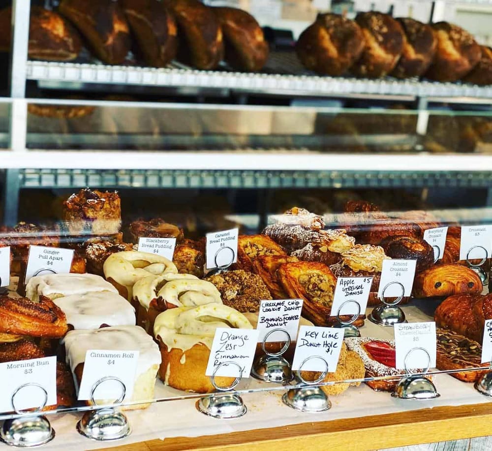 Fresh bakery donuts and bread pastries display at QuestForDirections bakery shop.