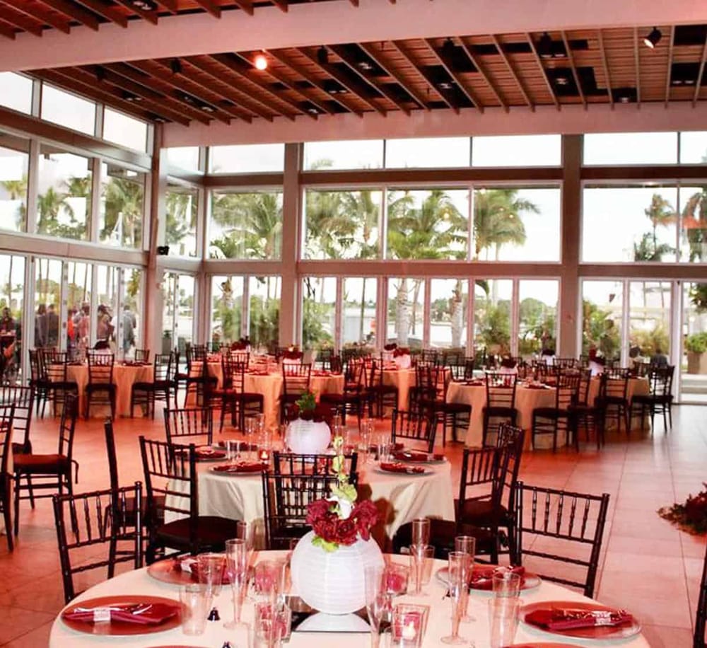 Elegant tropical event space with large windows and ocean views.