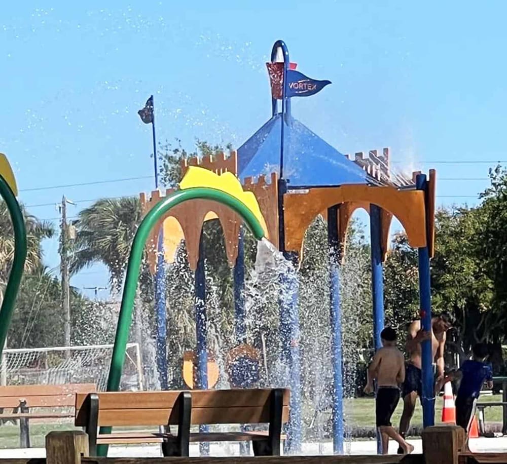 Colorful splash pad water play area at Quest for Directions playground, perfect for kids' fun.