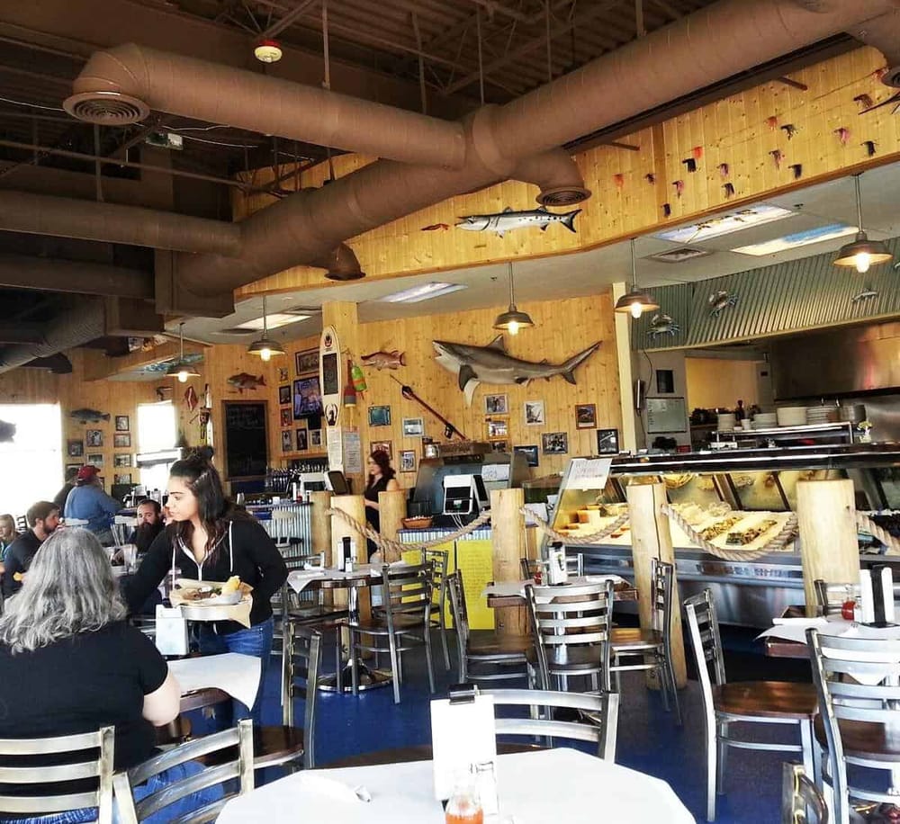Fresh seafood restaurant with coastal décor and marine fish displays, perfect for casual dining.