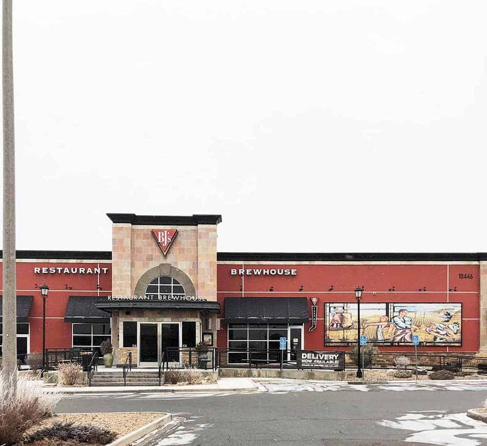 Modern restaurant and brewhouse exterior with signage and landscaped parking lot, perfect for dining and beverage experiences.