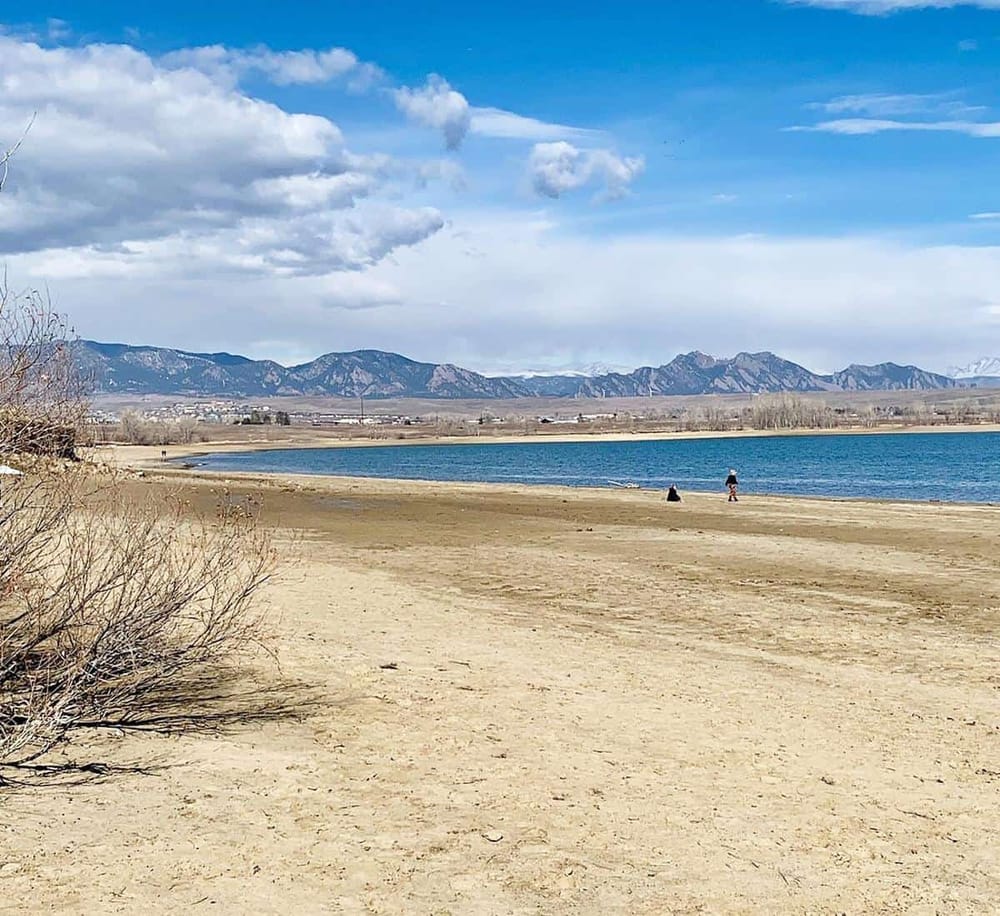 Serene beach landscape with mountains in the background, perfect for outdoor recreation and scenic views.
