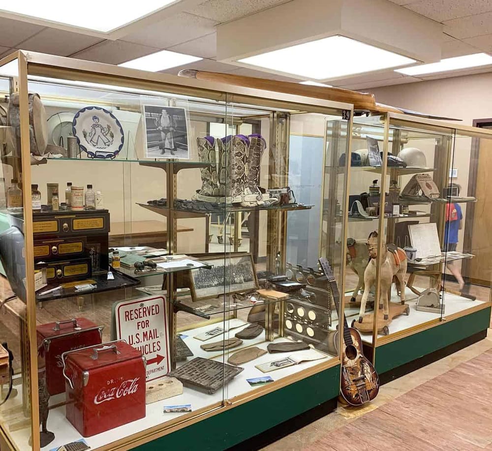 Antique collectibles display case with vintage memorabilia, military items, and nostalgic artifacts.