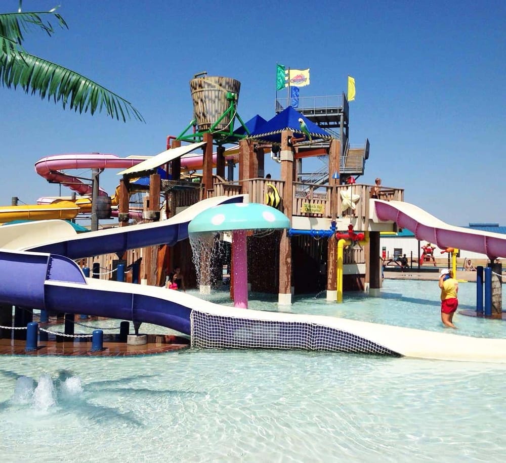 Colorful outdoor water park with multiple slides and splash features for kids and families.