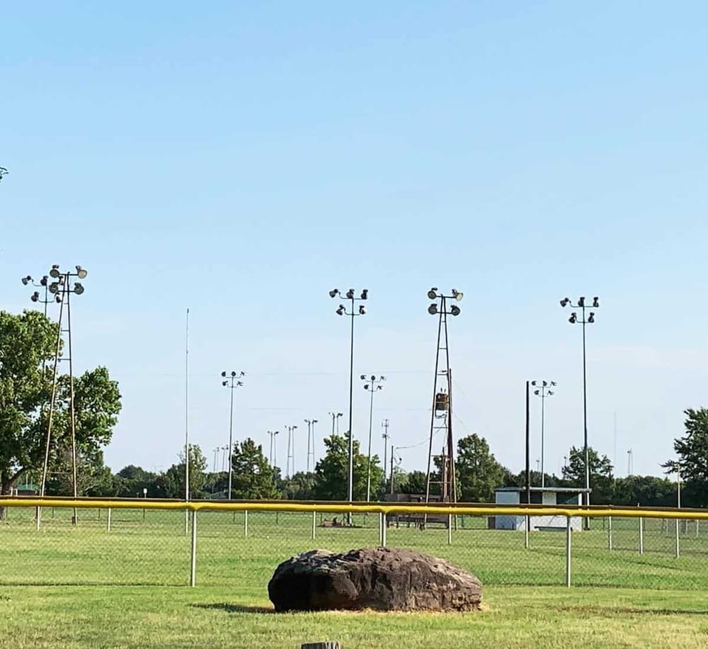 1. Empty sports field with tall floodlights under a clear blue sky.