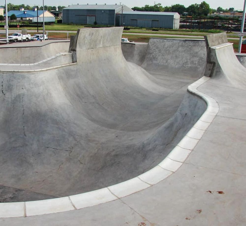 Skateboard skatepark bowl with smooth concrete surface for tricks and riding. Perfect for skateboarding enthusiasts.