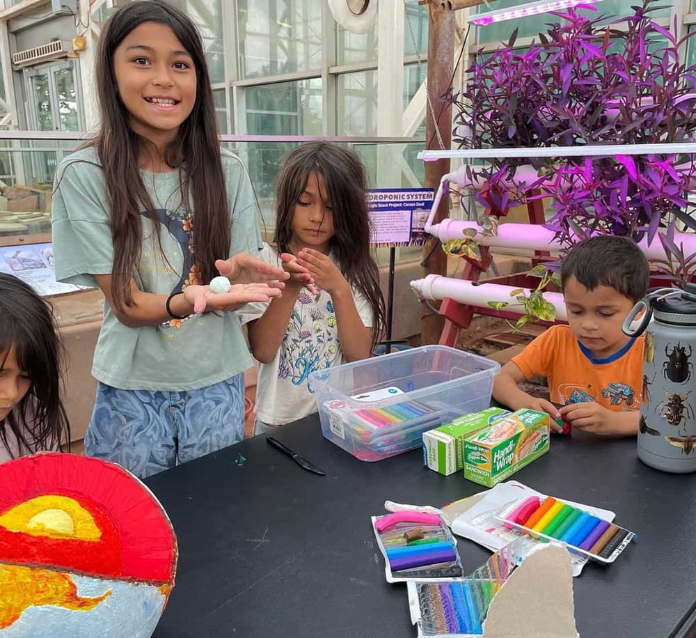 Colorful science activity in greenhouse with children at Quest for Directions.