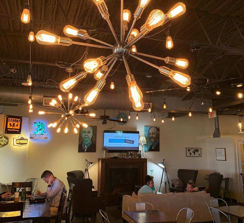 Modern industrial café lighting with Edison bulbs for cozy ambiance.