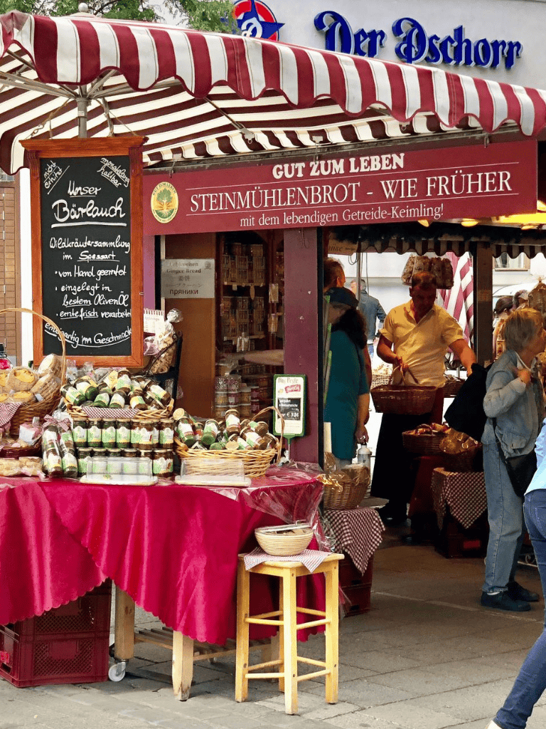 Fresh traditional market stall selling local baked goods and homemade products at a vibrant outdoor fair.