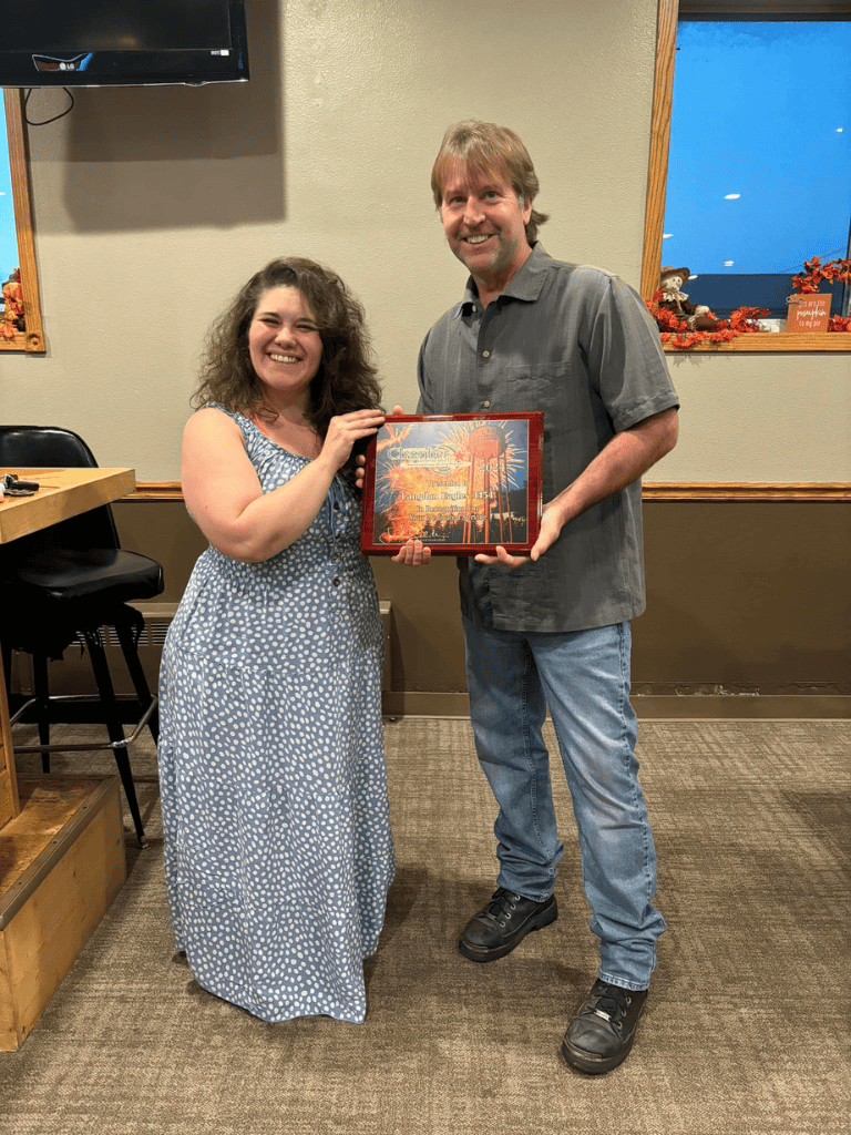 Happy woman receiving award at Quest for Directions event.