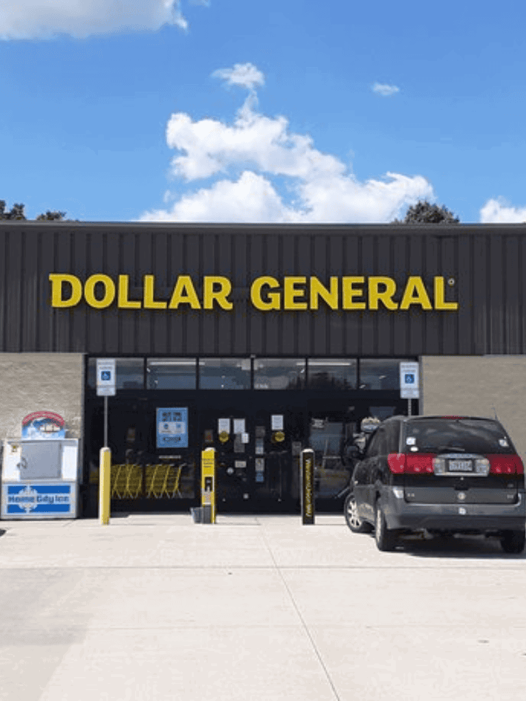 Dollar General store exterior with shopping carts and parking lot, accessible parking signs.