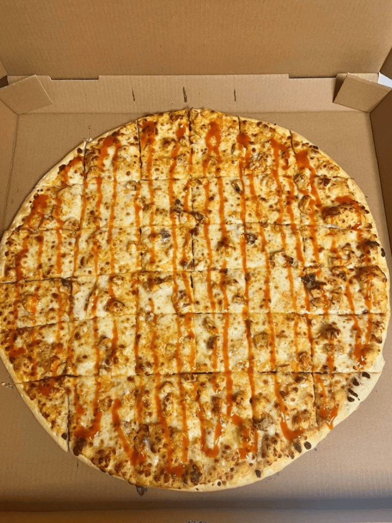 Cheese and BBQ chicken pizza in a cardboard box, ready to enjoy.