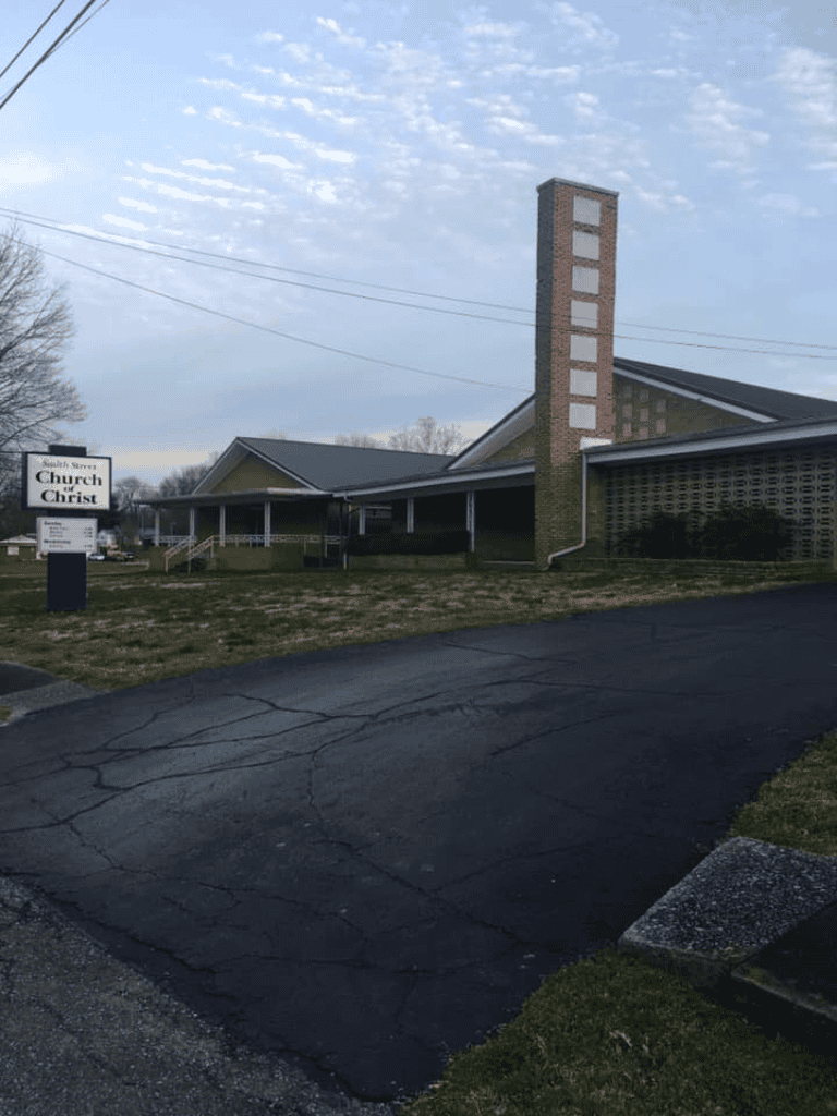 Church building with sign, Quest for Directions church, community, faith, religion, worship, church services, spiritual guidance.