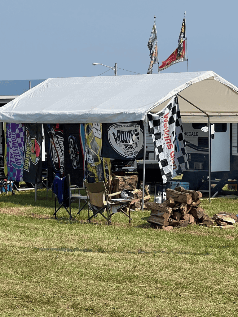 Race car flags and banners at a motorsports event tent setup at QuestForDirections event.