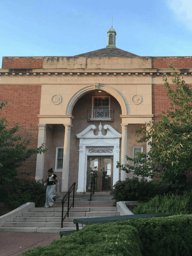 Historic California library building with classic architecture and lush greenery.