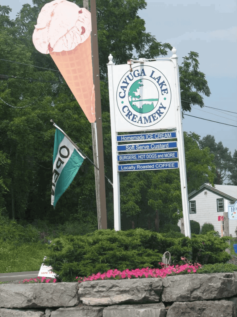 Ice cream cone sign at Cayuga Lake Creamery with local food offerings and coffee — a popular destination for travelers.