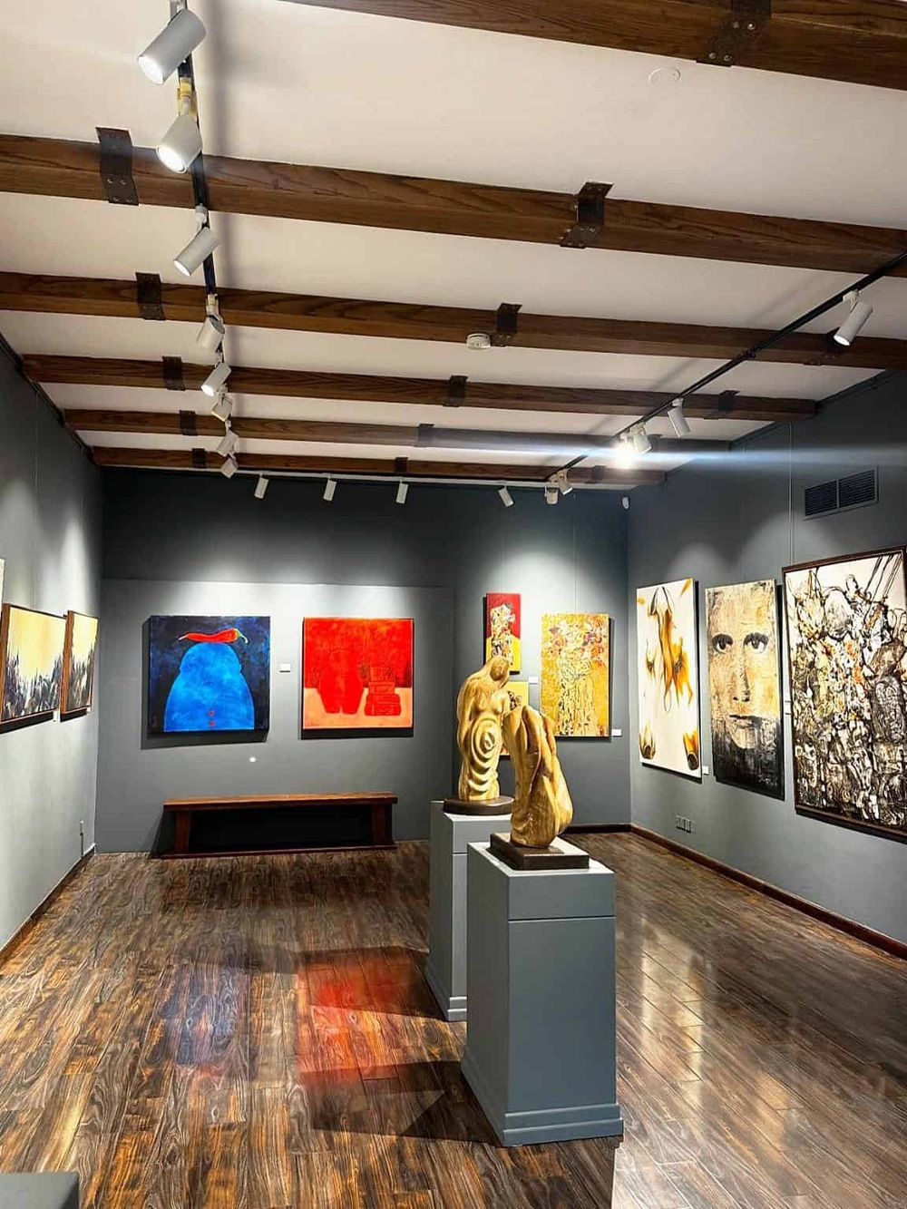 Vibrant modern art gallery showcasing sculptures and colorful paintings at QuestForDirections.