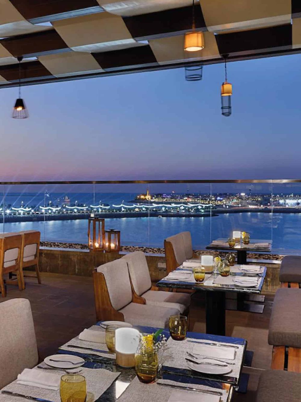 Panoramic waterfront dining experience at QuestForDirections restaurant with city views and elegant decor.