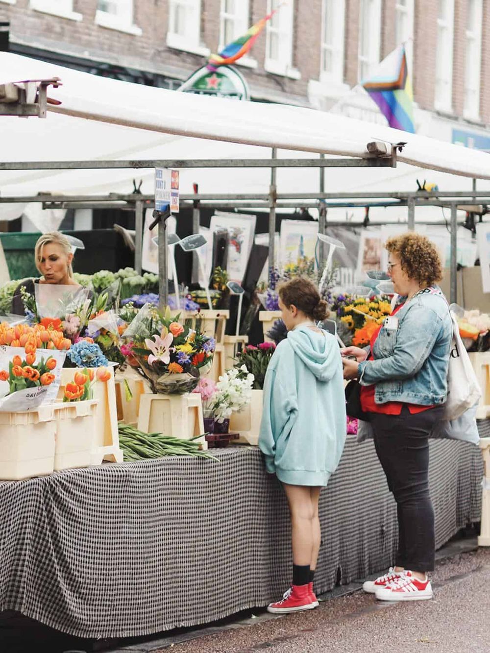Colorful flower market at QuestForDirections urban street, vibrant, fresh flowers, busy outdoor marketplace, browsing flowers, city life vibe.