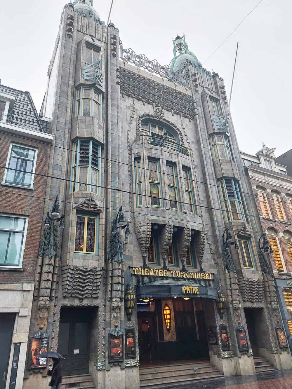 Intricate and historic Tudor-style building with decorative details, located on a city street.