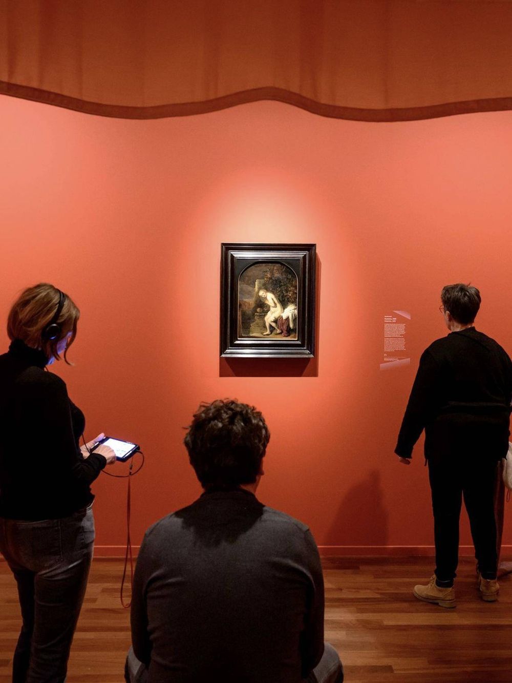 Vivid art museum scene with visitors viewing classic paintings in a gallery.