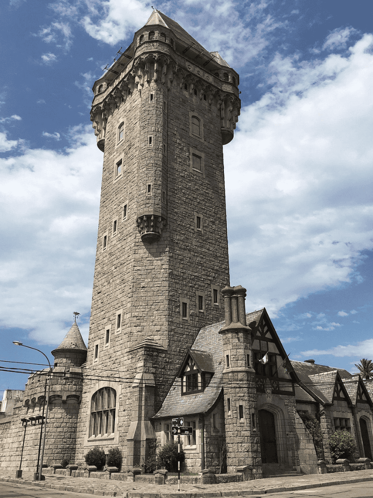 Ancient stone castle tower with medieval architecture, tall turret and detailed stonework.