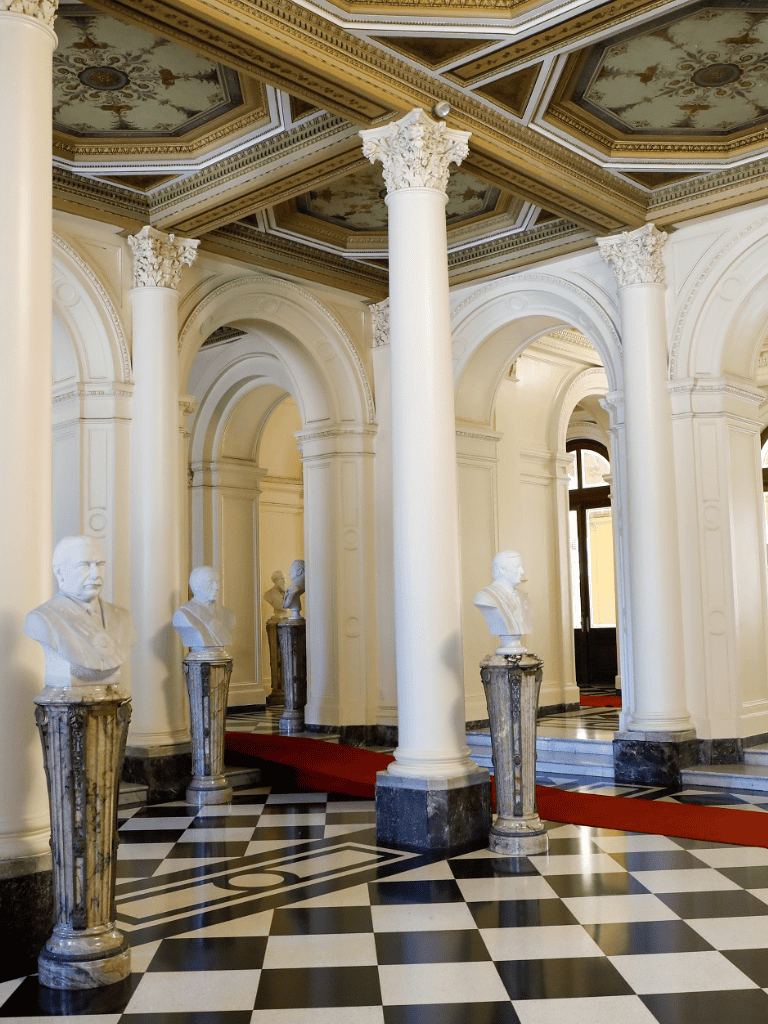 Elegant historical interior with marble busts and grand architecture - QuestForDirections.