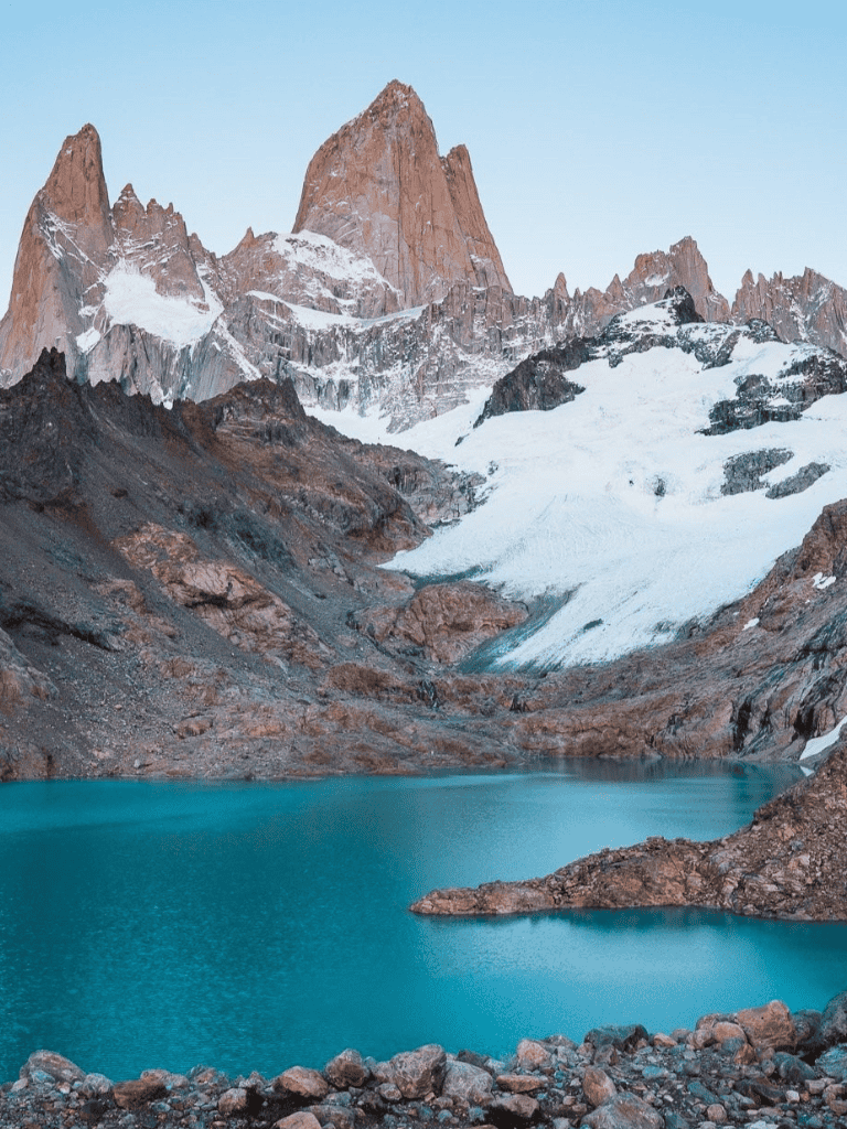 Snow-capped mountains and turquoise lake at Patagonia mountain landscape.