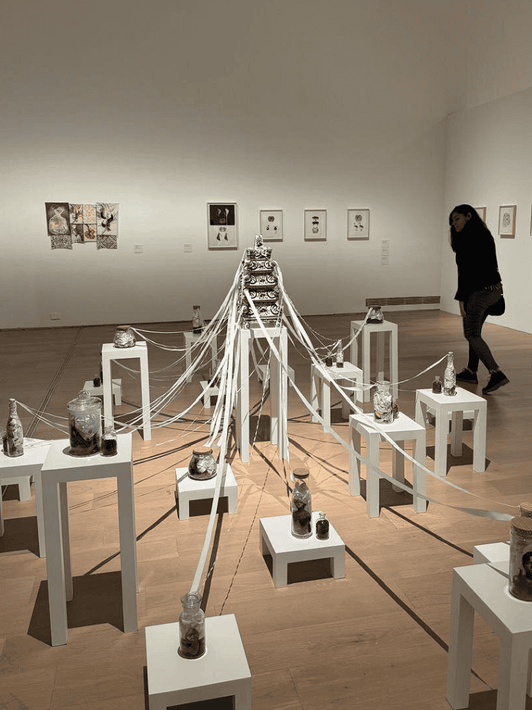 Vase art installation with jars and ribbons at QuestForDirections art exhibit.