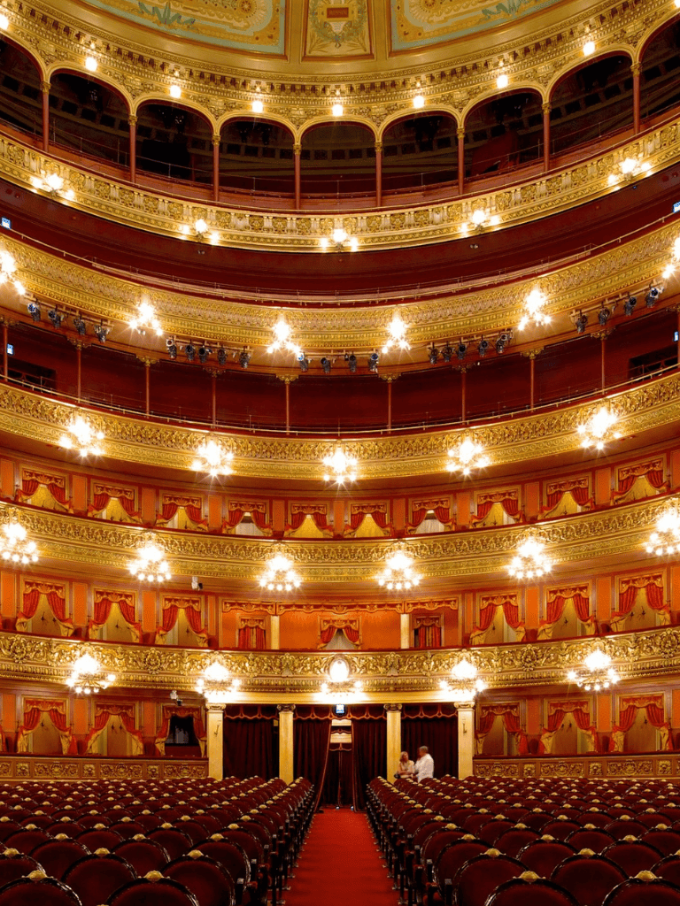 Elegant historic theater interior with ornate gold detailing and plush seating, perfect for performances and cultural events.