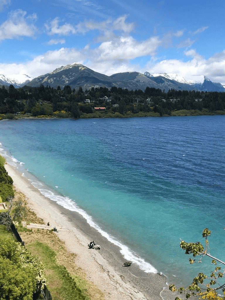 Stunning mountain and lake view with beach, perfect for outdoor navigation and travel planning.