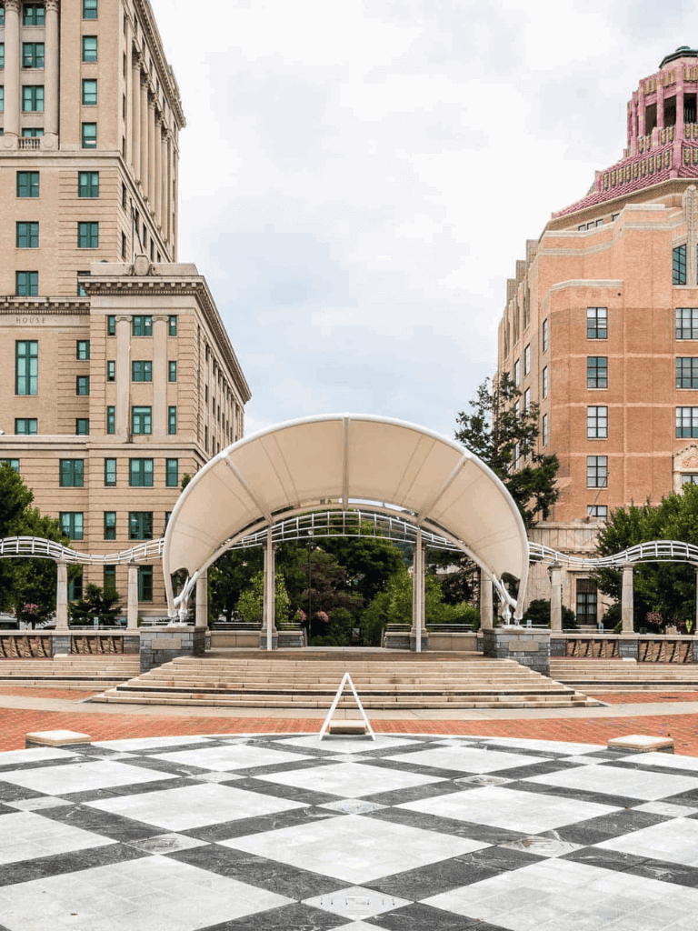 Historic city square with architectural buildings and open pavilion, perfect for urban exploration.