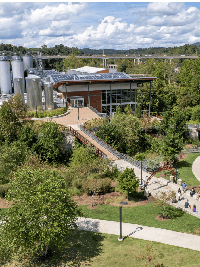 Modern eco-friendly building with solar panels and lush greenery at QuestForDirections.