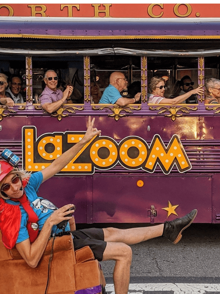 Joyful group on a colorful themed trolley ride in New Orleans.