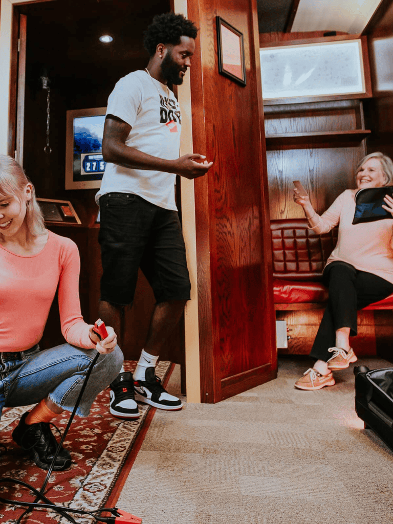 Relaxed group of friends enjoying fun moments during a road trip inside a cozy RV or camper van.