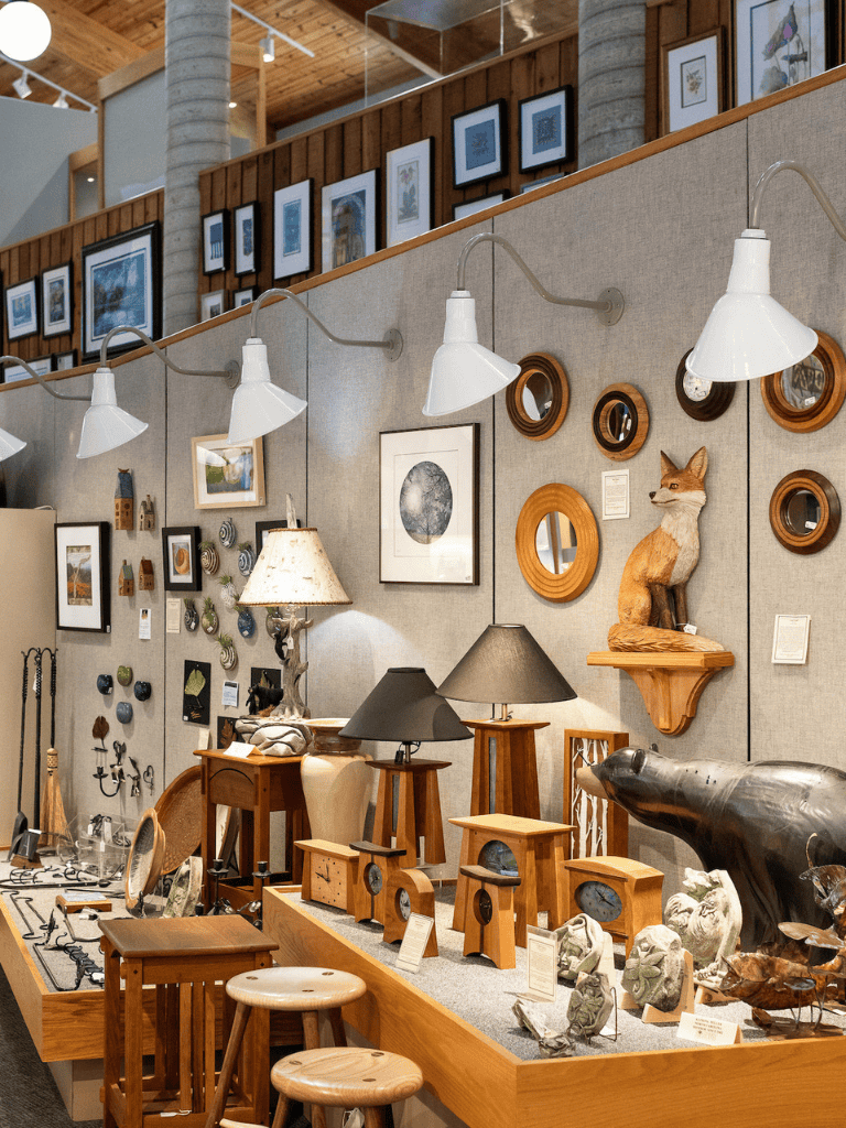 Colorful gallery wall of framed art and unique home decor items at Quest for Directions.