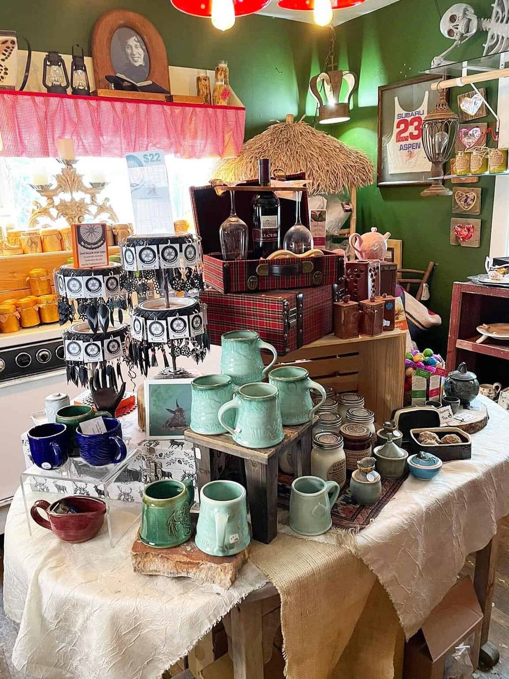 Colorful vintage ceramic mugs, pottery, and home decor items at a boutique shop display.