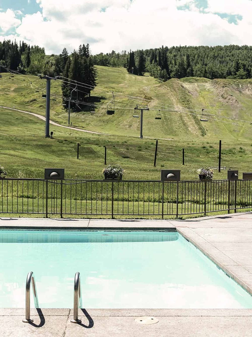 Scenic mountain view with ski lift and outdoor pool, perfect for relaxing and outdoor recreation.