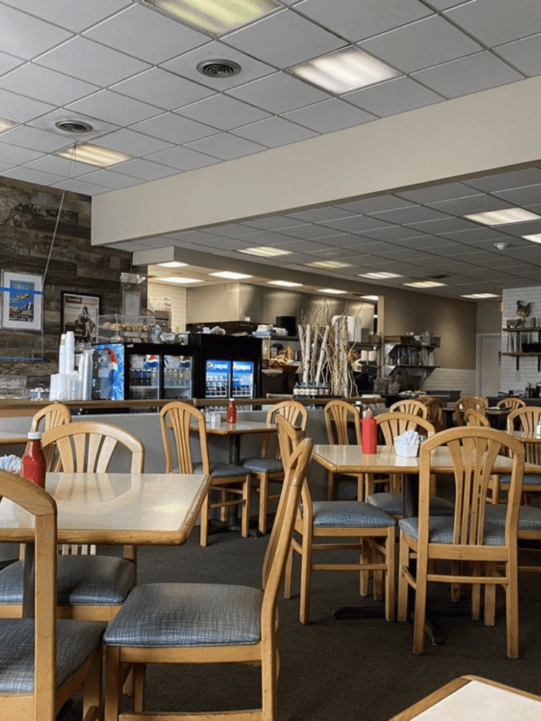 Empty dining area with wooden tables and chairs at QuestForDirections restaurant.
